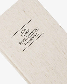 Close view of the linen journal cover with The Five Minute Journal text.