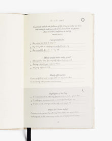 Open journal page with visible gratitude and daily affirmation prompts.
