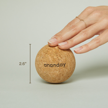 Hand resting on an Ananday cork ball beside a visible 2.6-inch measurement.
