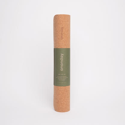Rolled cork yoga mat with Ananday label on a white background.