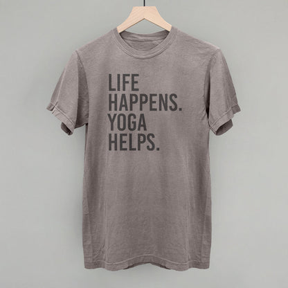 Taupe short-sleeve shirt on a hanger with visible printed text, Life Happens. Yoga Helps.