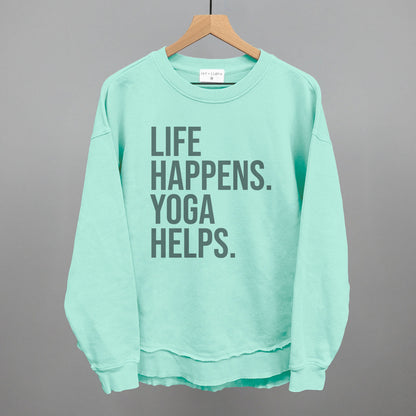 Mint textured long-sleeve top on a hanger with visible printed text, Life Happens. Yoga Helps.