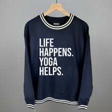 Navy striped-trim sweatshirt on a hanger with visible printed text, Life Happens. Yoga Helps.