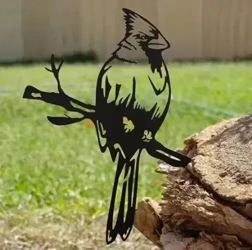 Black cardinal silhouette decoration displayed beside wood.