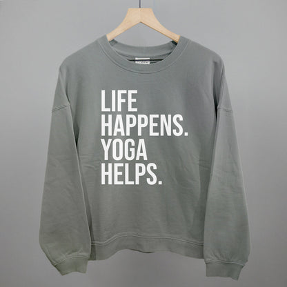 Gray sweatshirt on a hanger with visible printed text, Life Happens. Yoga Helps.