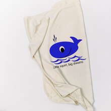 Natural cotton Big Dreams baby blanket with a blue whale folded on a white background