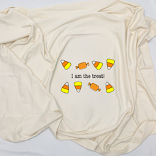 Close view of a natural cotton baby blanket with candy graphics and I Am the Treat text