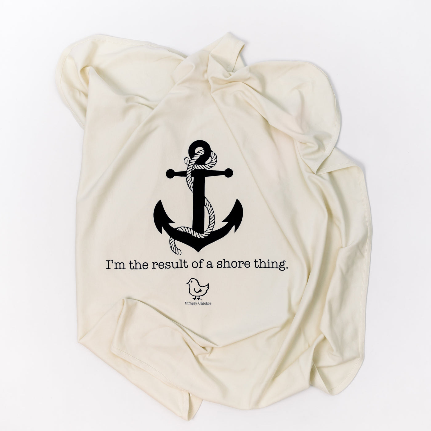 Natural cotton baby blanket with a black anchor and Shore Thing design folded on a white background