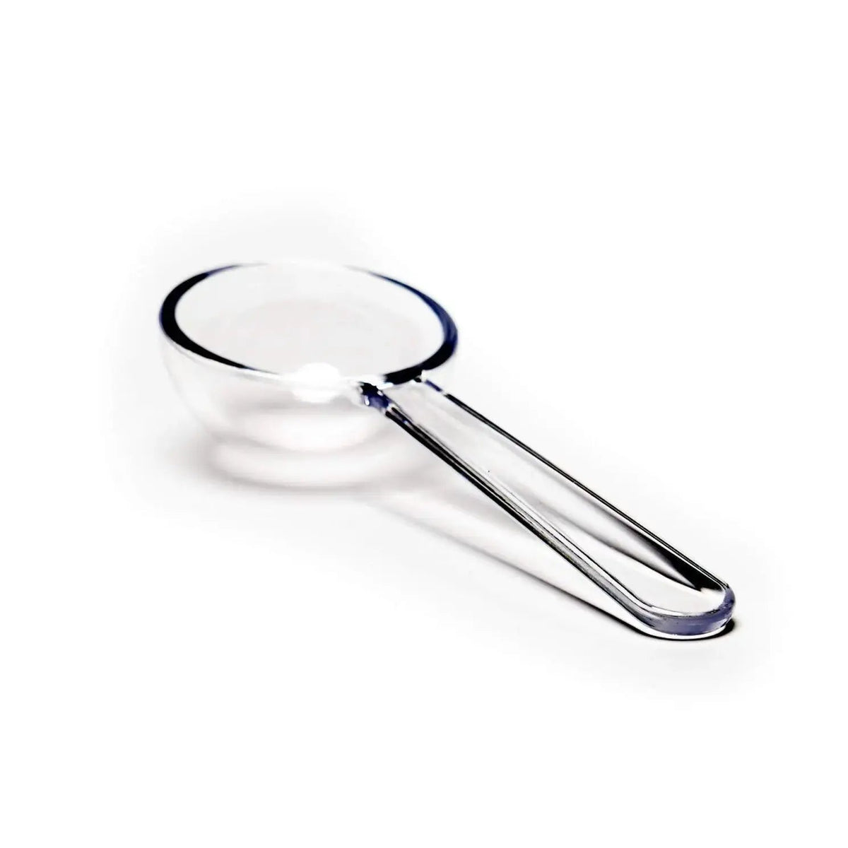 Clear handled tea strainer on a white background.