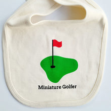 White bib with green golf green, red flag, and “Miniature Golfer” text on a white background.