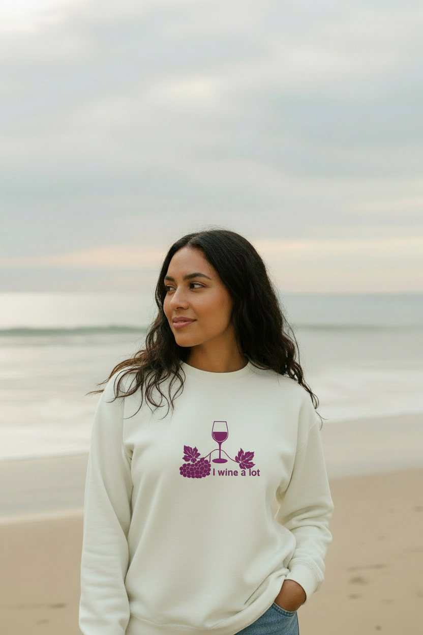 Woman wearing a natural cotton I Wine a Lot sweatshirt near the beach