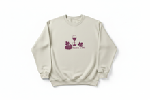 Natural cotton I Wine a Lot sweatshirt with wine glass and grape graphics shown flat