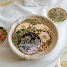 Moonlight Joshua Tree coaster displayed with colorful botanical enamel coasters in a shallow bowl