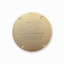Back of the gold-plated Moonlight Joshua Tree coaster showing four clear rubber feet and care instructions