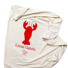 Natural cotton baby blanket with a red Local Catch lobster folded on a white background