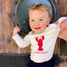 Toddler wearing a natural cotton long-sleeve romper with a red Local Catch lobster design