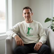 Man wearing a natural cotton Ski Bum sweatshirt while seated indoors