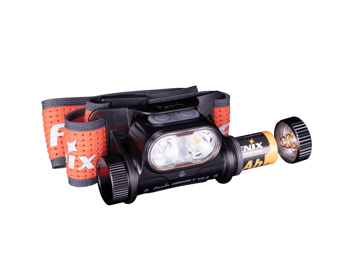 Fenix headlamp with battery and open battery cap on a transparent background.