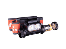 Fenix headlamp with battery and open battery cap on a transparent background.