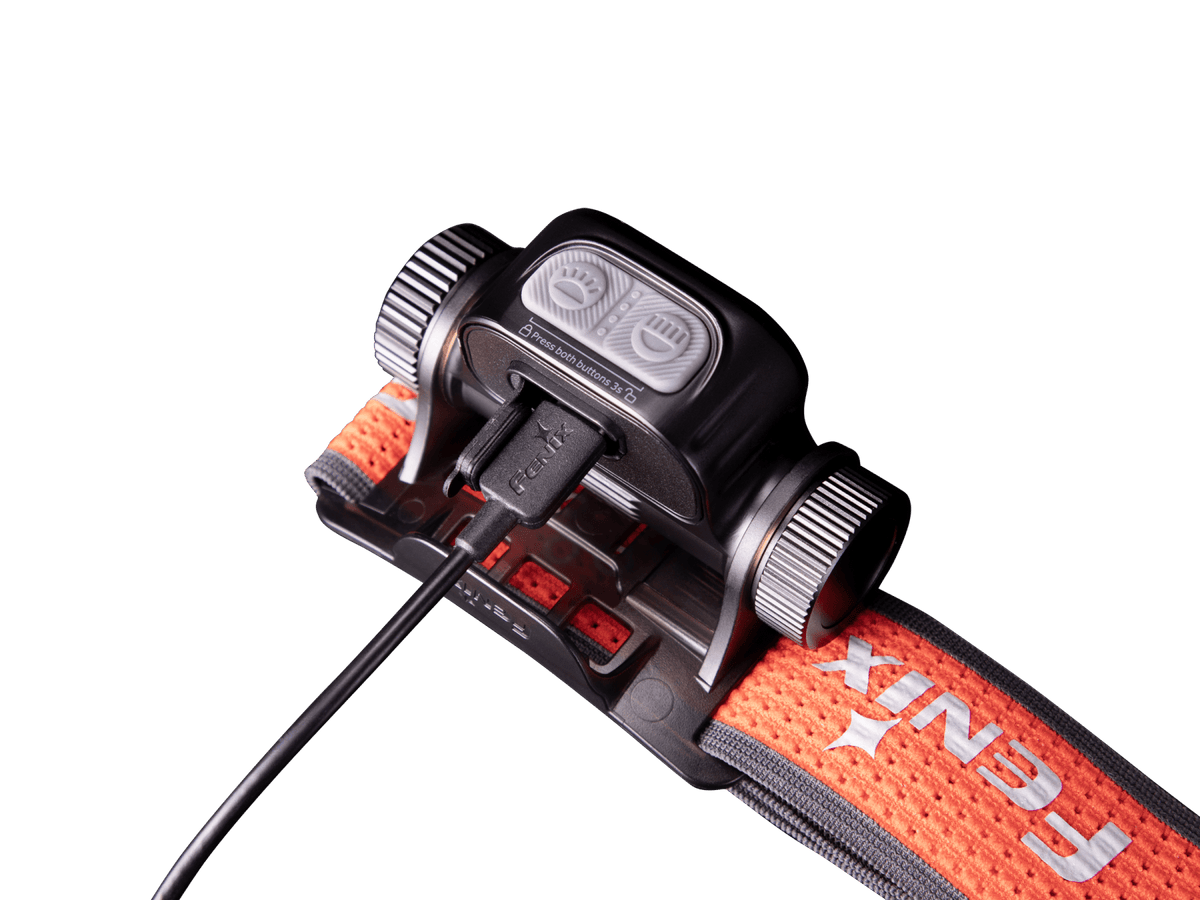 Close-up of a Fenix headlamp charging through a cable.