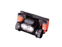 Close-up of a black Fenix headlamp with orange headband.