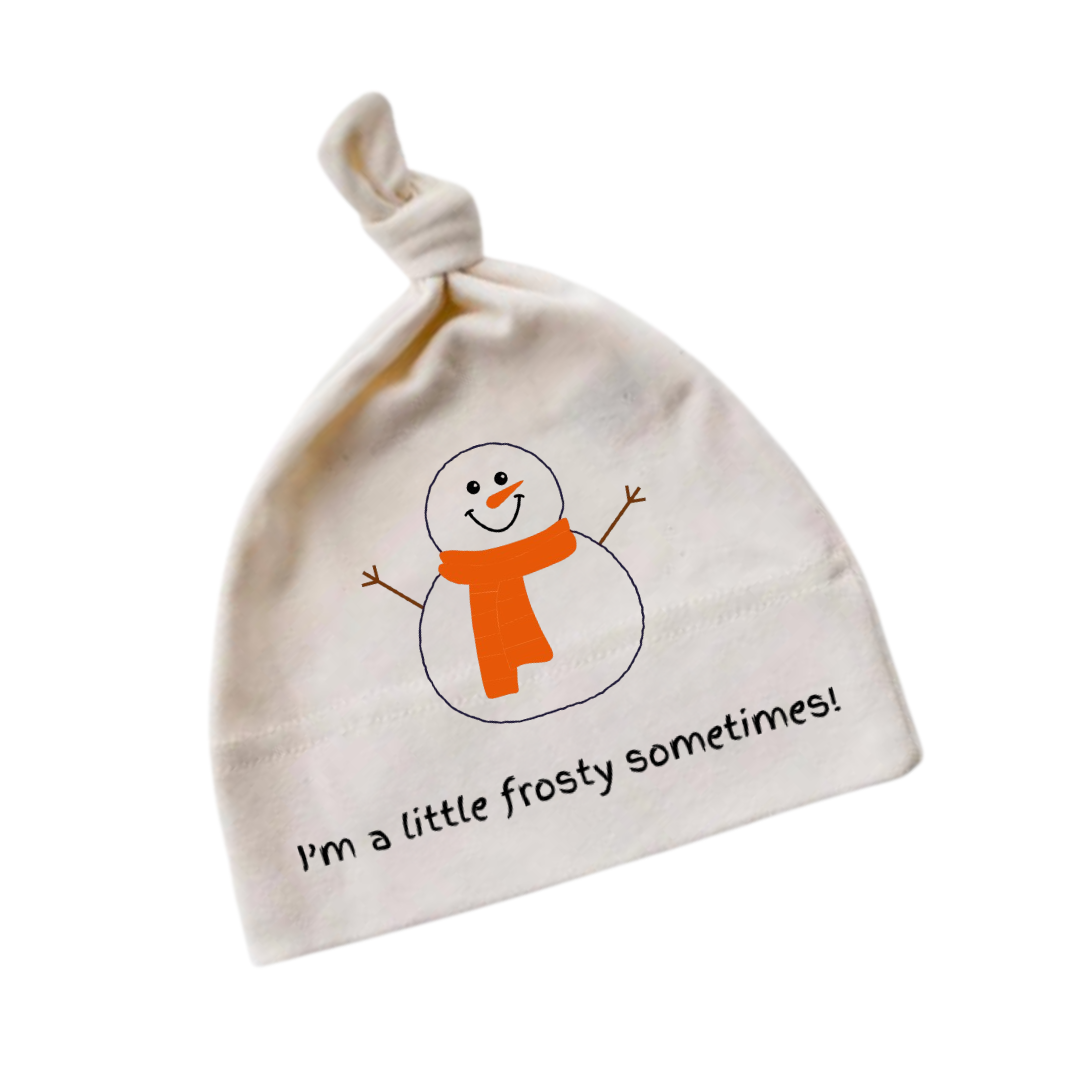White knotted baby hat with snowman graphic, orange scarf, and “I’m a little frosty sometimes!” text on a white background.