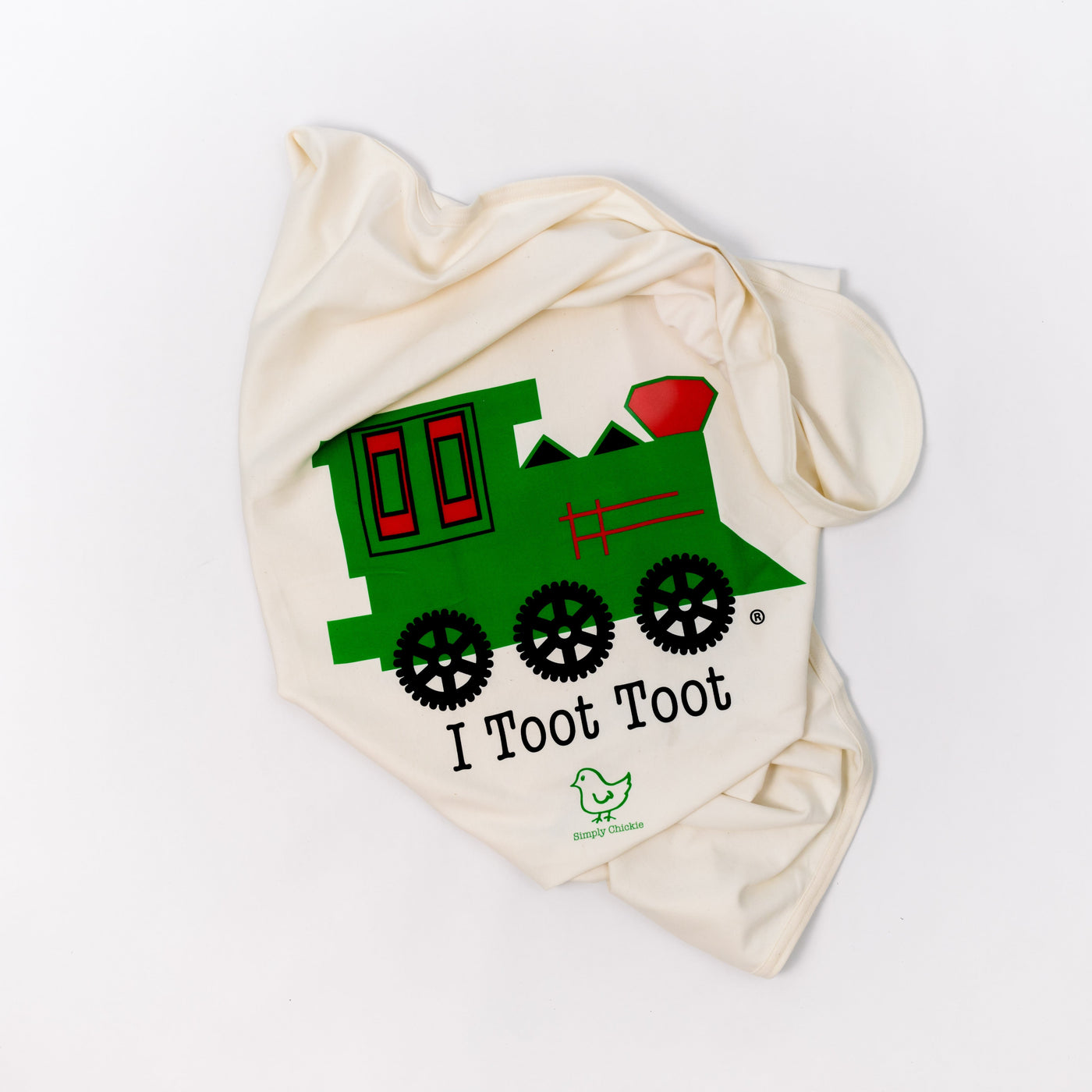 Natural cotton baby blanket with a green train and I Toot Toot design folded on a white background