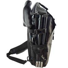 Side view of a gray backpack with folded black travel poles secured to the exterior.
