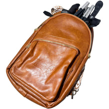 Brown York Nordic backpack holding folded black poles.