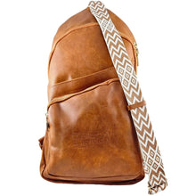 Brown York Nordic backpack with a patterned shoulder strap on a white background.